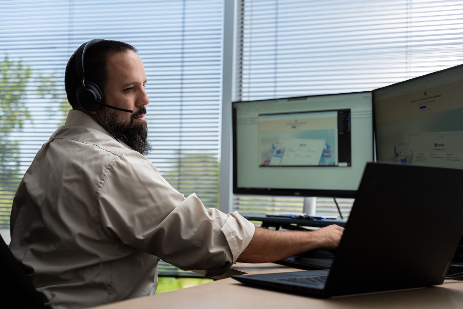 team member working on multiple screens